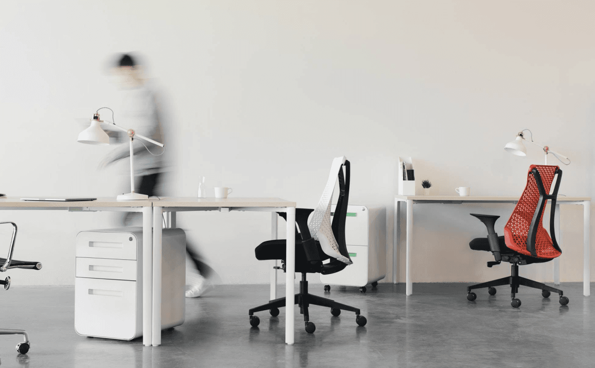 Modern office workspace with white desks and chairs